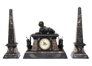 An Egyptian Revival marble and slate mantel clock garniture,