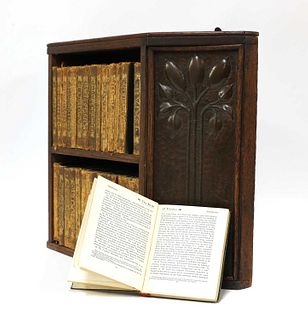 An Arts and Crafts oak hanging bookshelf,