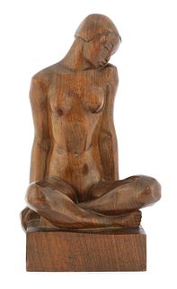 A carved wood sculpture of a nude,