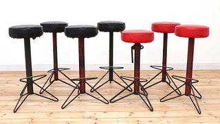 Seven industrial steel bar stools,