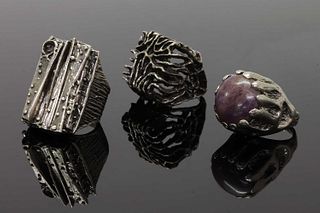 A collection of three naturalistic silver rings,