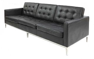 A modern 'Relax'-style black leather sofa,