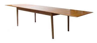 An extending teak dining table,