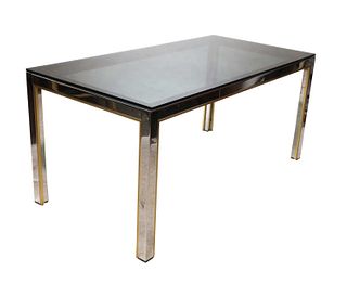 A chrome and brass dining table,