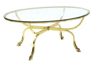 An oval brass and glass coffee table,