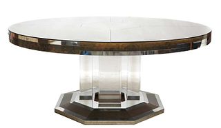 A massive circular glass-panelled dining table,