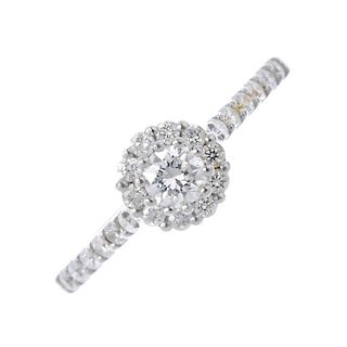 A platinum diamond cluster ring. The brilliant-cut diamond, with similarly-cut diamond surround and