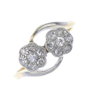 An early 20th century 18ct gold diamond floral cluster ring. Designed as two single-cut diamond flor