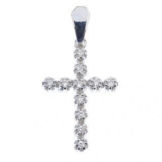 A diamond cross pendant and a fleur-de-lys pendant. The brilliant-cut diamond cross, suspended from