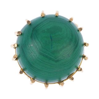 A malachite single-stone ring. The circular malachite cabochon, to the hoop and sphere shoulders and