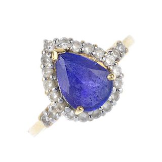 A coated tanzanite and diamond cluster ring. The pear-shape coated tanzanite, within a brilliant-cut