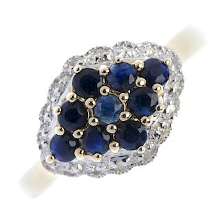 A 9ct gold sapphire and diamond dress ring. The circular-shape sapphire panel, within a single-cut d