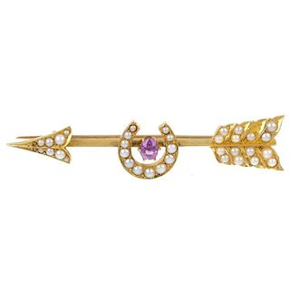 A sapphire and split pearl arrow and horseshoe brooch. The oval-shape pink sapphire and split pearl