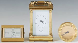 Group of Three Gilt Bronze Clocks, 20th c., consisting of an English carriage Clock by Comitti, London; a Tiffany & Co. folding easel travel clock, an
