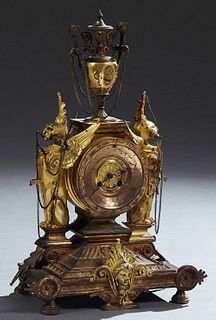 French Gilt Bronze Figural Mantle Clock, 19th c., the urn surmount with draping chains connected to figural winged griffins, above a brass face drum c