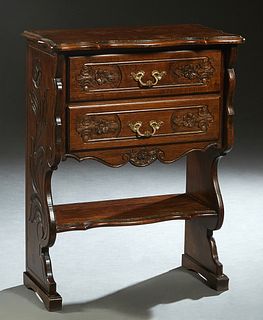 French Louis XV Style Art Nouveau Carved Oak Side table, early 20th c., the stepped serpentine top over two floral carved drawers above a lower shelf,