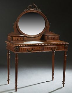 French Louis XVI Style Carved Walnut Dressing Table, c. 1890, the pierced bow and garland crest atop an oval wide beveled swiveling mirror, on a yoke 