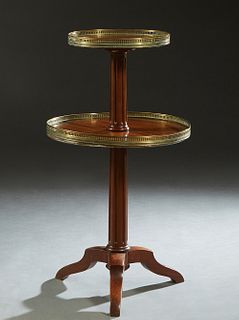 French Louis XVI Style Two Tier Brass Mounted Dumbwaiter, 20th c., with a pierced brass galleried upper shelf on a reeded tapered support to a larger 