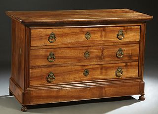 French Louis Philippe Carved Walnut Commode, 19th c., the stepped rounded corner top over three drawers with figural brass pulls, on a plinth base, on