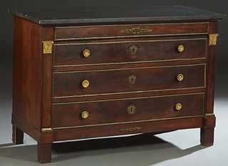 French Empire Ormolu Mounted Carved Mahogany Marble Top Commode, 19th c., the figured black marble over a frieze drawer and three setback drawers, fla
