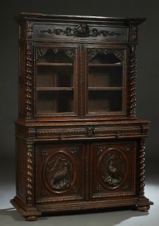 French Henri II Style Carved Oak Buffet a Deux Corps, c. 1880, the stepped breakfront crown over a setback frieze and double glazed cupboard doors, fl