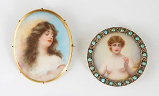 Two Painted Porcelain Brooches, late 19th c., a circular example of "Klotho," one of the Greek Gods of Fate, in a circular brass frame mounted with ca