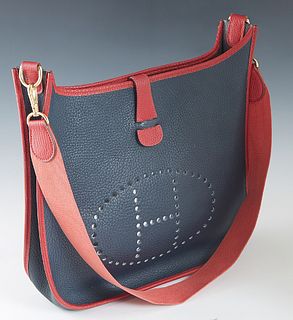 Hermes Evelyne Bicolor PM Shoulder Bag, c. 1995, in red and navy blue buffalo calf leather with gold hardware, the snap button closure opening to a na