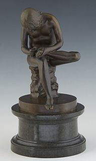 Continental School, "El Spinario," (The Thorn Picker), late 19th c., after the antique, patinated bronze on an integral circular base on a stepped bla