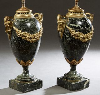 Pair of Gilt Bronze Mounted Louis XVI Style Marble Urn Lamps, 20th c., the highly figured black marble baluster urns mounted with ormolu rams' head ha