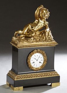 French Gilt Bronze and Black Marble Figural Mantel Clock 19th c., with a surmount of a reclining putto with grapes, atop a black marble case with an e