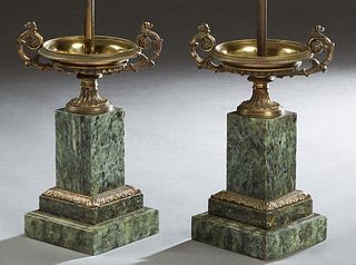 Pair of French Gilt Bronze and Marble Lamps, early 20th c., with gilt bronze coupes on socle supports, to stepped bronze mounted figured green marble 