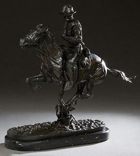 After Frederic Remington (1861-1909), "Trooper of the Plains," late 20th c., patinated bronze, mounted on a thick figured black marble base, H.- 23 1/