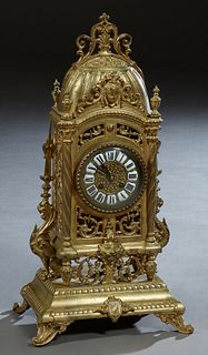 French Gilt Bronze Louis XV Style Mantel Clock, 19th c., by Japy Freres, the domed top with a central relief head over a pierced case and a time and s