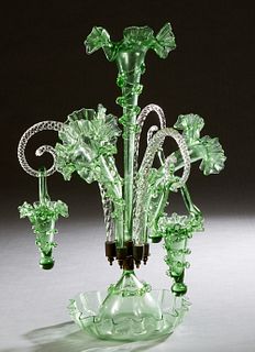 Fine Victorian Blown Green Glass Epergne, 19th c., with a central glass floriform trumpet vase, flanked by three angled florifom vases and three swirl