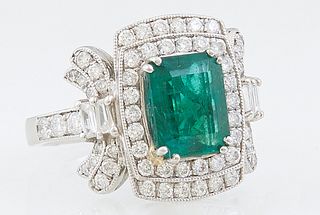 Lady's Platinum Dinner Ring, with a 2.34 carat emerald atop a stepped graduated border of round diamonds, flanked by baguette diamond mounted lugs and