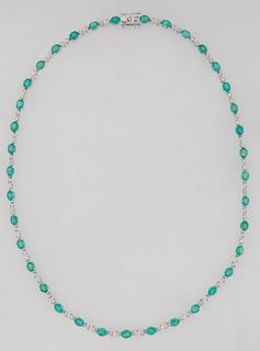 18K White Gold Link Necklace, each of the thirty-seven links with an oval emerald, joined by two small round diamond mounted links, total emerald wt.-
