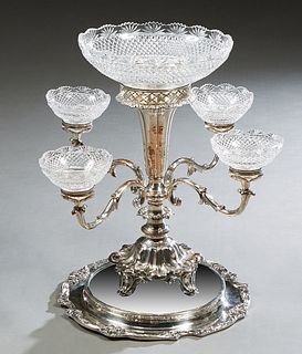 Silverplated Epergne/Centerpiece, with a cut crystal center bowl on a trumpet form support, issuing four scrolled arms with crystal bowls, on a circul