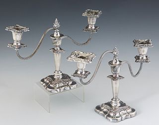 Pair of Georgian Style Silver Plated Copper Two Light Candelabra, 20th c., the central support with a flame finial, issuing two swirled arms with reli