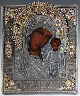 Russian Icon of the Virgin of Kazan, late 19th c., with a silverplated and enamel oklad, unmarked, on a gold velvet covered back plate, H.- 12 7/8 in.