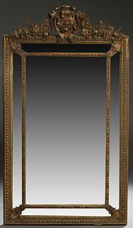 French Louis XV Style Gilt and Gesso Beech Overmantel Mirror, 19th c. , with an arched pierced floral crest over a cushion mirror with a relief frame 