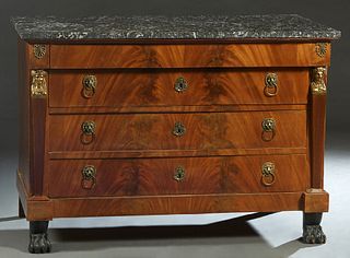 French Empire Style Carved Mahogany Marble Top Commode, 19th c., the highly figured rectangular black marble over a frieze drawer and three setback dr