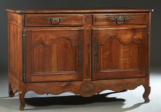 French Provincial Carved Cherry Louis XV Style Sideboard, early 19th c., the canted corner top over two frieze drawers with iron pulls and escutcheons