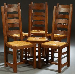 Set of Six French Provincial Carved Oak Ladderback Rushseat Dining Chairs, 20th c., the high canted back over a woven rush slip seat, joined by an H-f