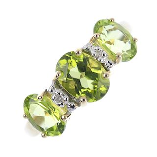 A 9ct gold peridot and diamond ring. The oval-shape period, within single-cut diamond spacers. Hallm