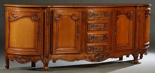 French Louis XV Style Carved Cherry Sideboard, 20th c., the parquetry inlaid serpentine top over a central bank of four drawers, flanked by concave fi