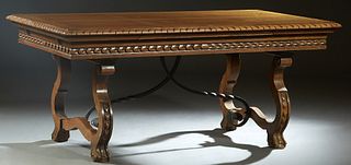 French Henri II Style Carved Oak Drawleaf Table, c. 1880, the stepped carved rounded edge top over two draw leaves, above a lappet carved skirt, on la