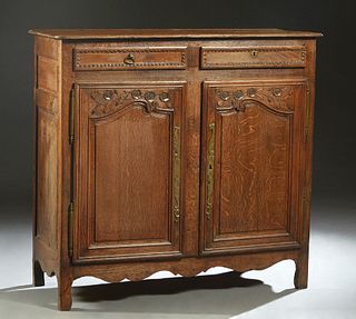 French Provincial Louis XV Style Carved Oak Sideboard, 19th c., the stepped rounded corner top over two frieze drawers, above double fielded panel cup