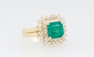 Lady's 14K Yellow Gold Dinner Ring, with a square 2.11 ct. emerald atop a double graduated concentric border of round diamonds, flanked by a split sho