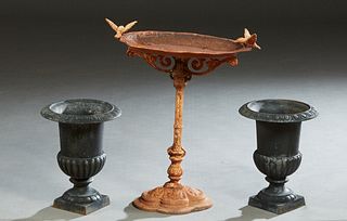 Three Cast Iron Garden Pieces, 20th/21st c., consisting of a pair of small campana form jardinieres, the everted relief rim over a lobed side to a squ