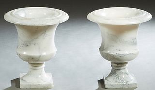 Pair of White Carved Marble Campana Form Urns, 20th c., the everted rims over baluster sides on socle supports to square bases, H.- 17 1/2 in., Dia.- 